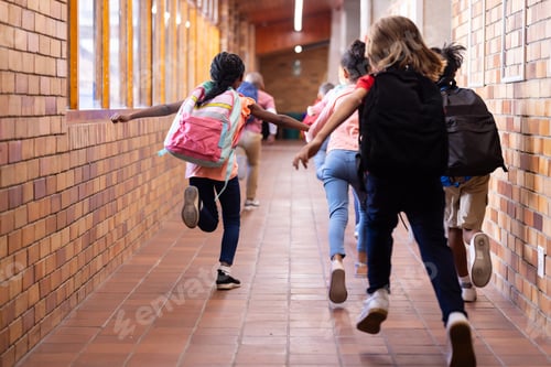 Preview: Running in school hallway, group of diverse children with backpacks heading to class