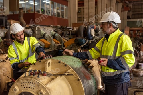 Preview: Worker at machine in factory, Metal industry worker at factory.