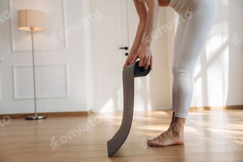 Preview: Preparing, with mat. Yoga time, close up view of woman that is practicing at home