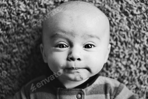 Preview: Little baby with funny face overhead shot