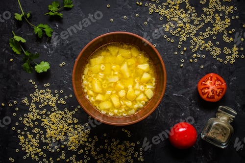 Preview: Soup Anelli Pasta And Vegetables. Vegan Food. (Dark Background). Top View. Copy Space
