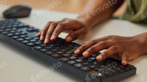 Preview: Young employee typing information on computer