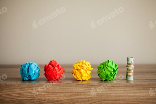 Preview: Great idea concept. Crumpled colorful paper on wooden table. Copy space