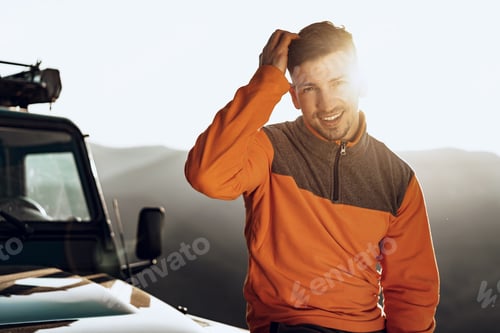 Preview: Portrait of a young caucasian man hiking in the mountains