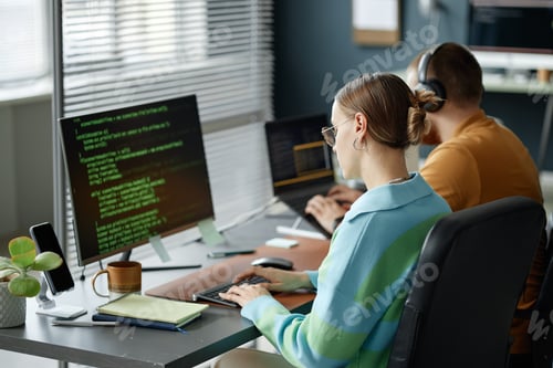 Preview: Young Woman Writing Code on Computer While Working in Modern Office