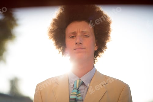 Preview: Portrait of teenage boy with red afro hair, wearing suit, outdoors