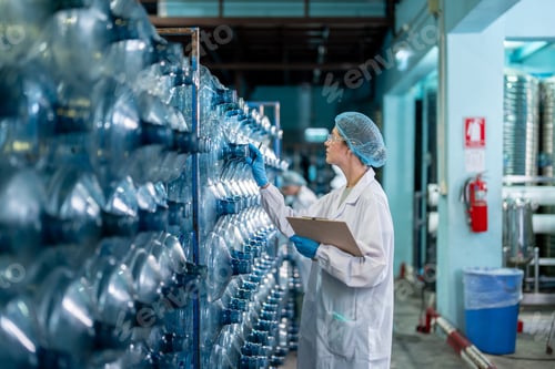 Preview: Caucasian female scientist working in laboratory at factory warehouse.