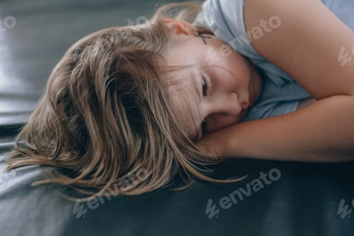 Preview: Sad girl lies on the floor