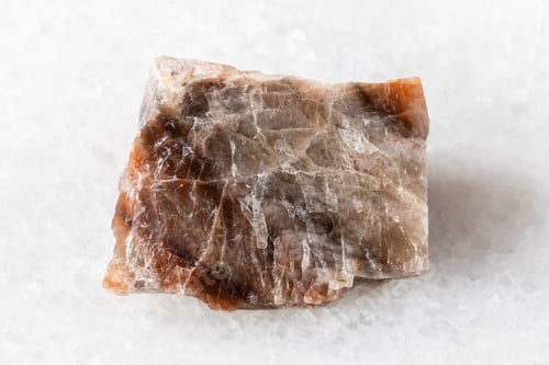 Preview: sample of raw nepheline rock on white marble