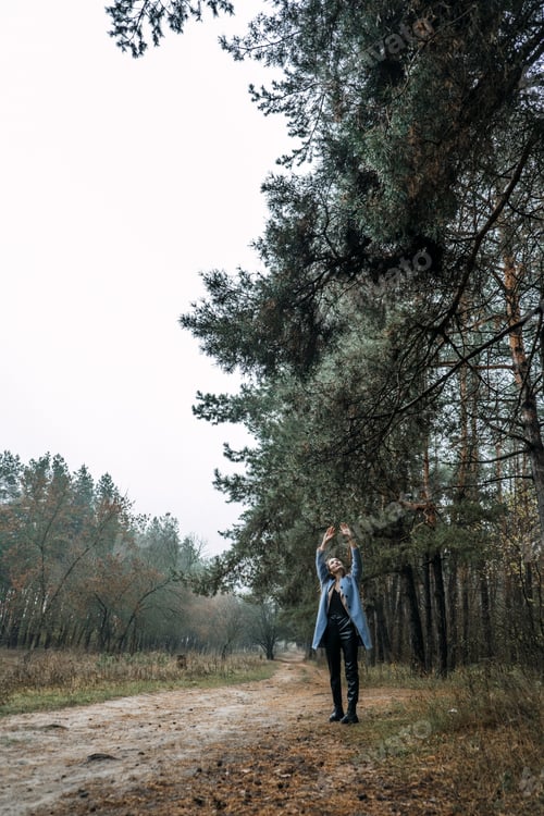 Preview: Improving mental wellbeing, Relax and reduce stress. young woman in red sweater touching water