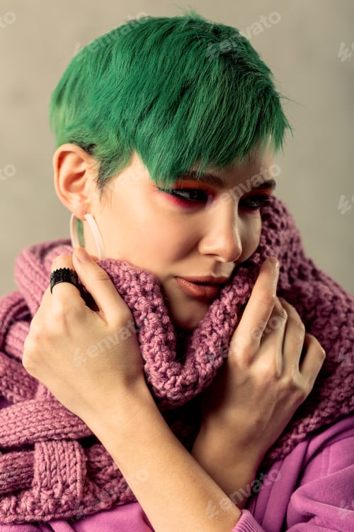 Preview: Absolutely Warm. Pleasant Beautiful Woman Looking Aside While Wearing A Beautiful Scarf