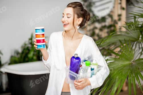 Preview: Woman with colorful bottles for self-care in the bathroom