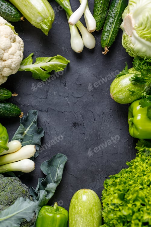 Preview: Frame of green raw vegetables on black background. Top view of healthy organic food. Copy space