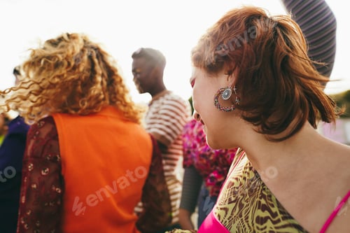 Preview: Happy young people dancing outdoor at festival event - Focus on right girl earring