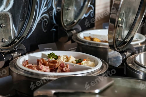 Preview: Hotel breakfast buffet line with hot bacon and mixed vegetables