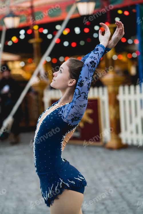 Preview: Rhythmic gymnast wearing colorful clothes practicing outdoors in the street of barcelona.