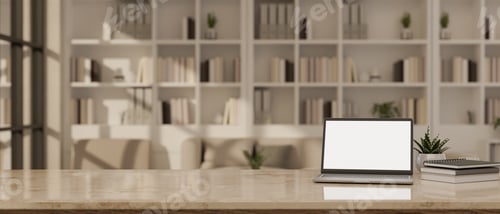 Preview: Blank screen laptop on marble table in study room with book shelf in the background