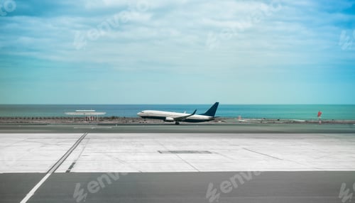Preview: airplane in Lanzarote airport runaway with sea on the background
