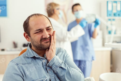 Preview: Man patient complaining about teeth pain while waiting for stomatologist doctors