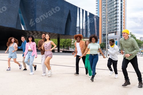 Preview: Happy playful multiethnic group of young friends bonding outdoors
