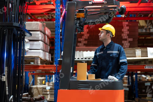 Preview: Male warehouse worker using forklift electric move cardboard boxes to shelves in store warehouse