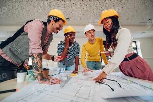 Preview: Multiracial team of architects having a meeting while using blueprints