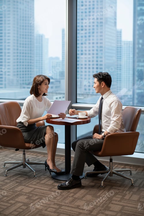 Preview: Chinese business people talking in office