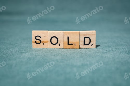 Preview: Sold sign on greenish background