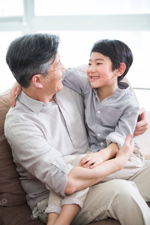 Preview: Cute grandson sitting on grandfather's lap