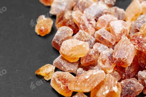 Preview: brown sugar rock organic crystalline close up on dark background