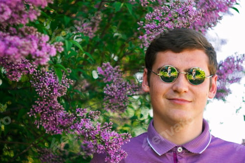 Preview: Defocus smiling man in circle sunglasses outdoors portrait. Spring people. Young men in purple shirt