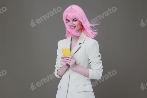 Preview: cheerful woman pink wig talking on the phone