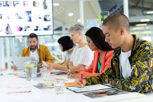 Preview: Side view of diverse business people discussing in the meeting at conference room in office