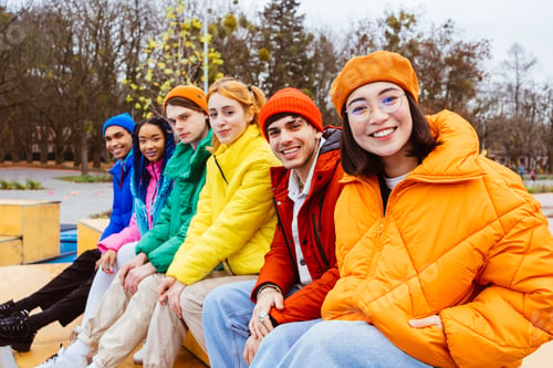 Preview: Multiracial group of young friends meeting outdoors in winter