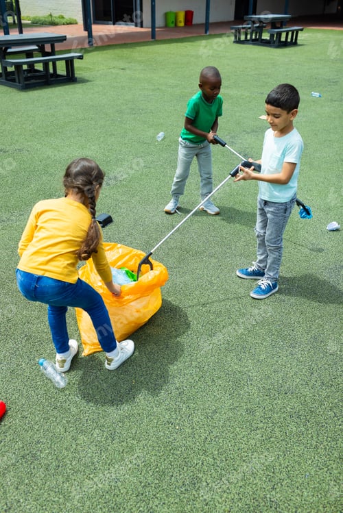 Preview: Children are picking up litter with grabbers in a playground at school