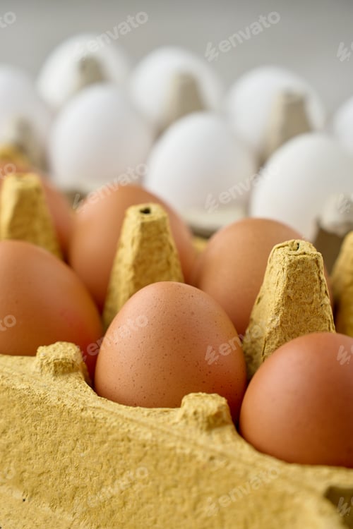Preview: Brown and white chicken eggs in cardboard cartons close up