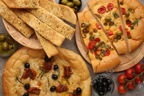 Preview: Focaccia alle olive - baked sandwich with green olives and rosemary on wooden background