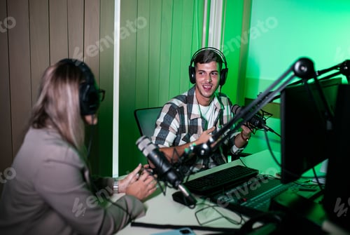 Preview: Male podcaster making podcast with young woman from his studio.