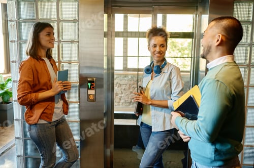 Preview: Happy cheerful coworkers chatting at workplace