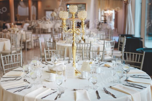 Preview: Shot of a gold chandelier candelabrum on a white wedding table