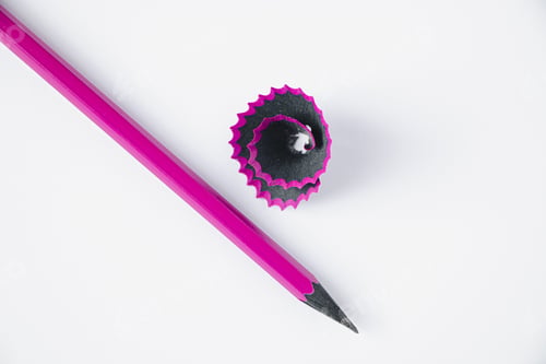 Preview: Wooden purple pencil and shavings on white background.