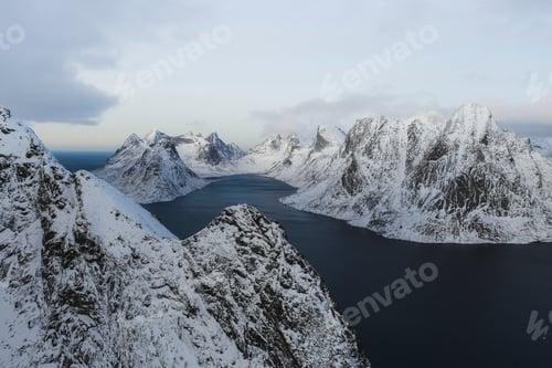 Preview: Drone view of a snowy mountain and ocean