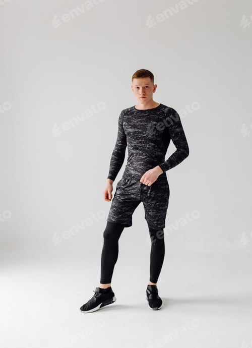 Preview: Athletic young man doing workouts at home, man doing training, warm up before weight exercise.