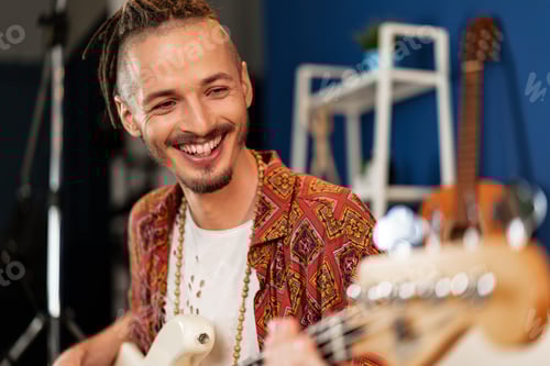 Preview: Smiling Man Playing Guitar with Orange Patterned Shirt
