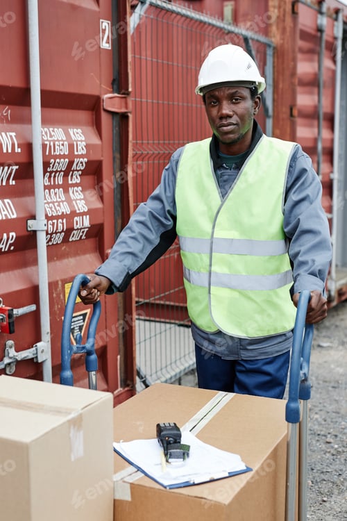 Preview: Worker pushing cart with boxes