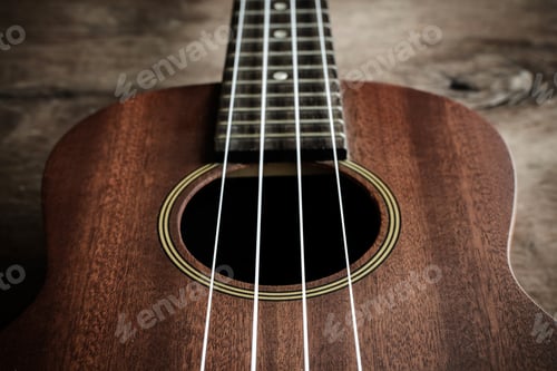 Preview: Close up of ukulele on old wood background