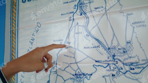 Preview: Closeup finger pointing map looking trip direction. Lost tourist planning route