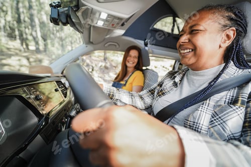 Preview: Multiracial senior women having fun on the road in camper van - Focus on african woman face
