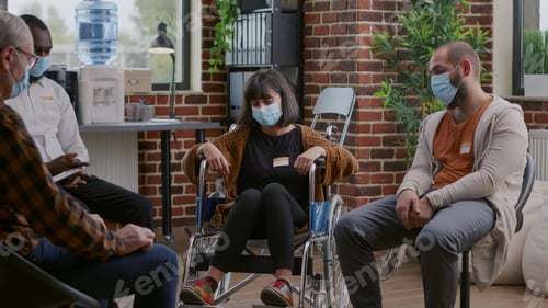 Preview: Woman with disability attending aa group therapy session with people in circle