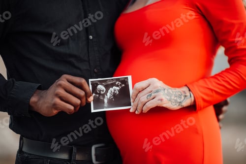 Preview: Young beautiful interracial millennial couple expecting a baby.